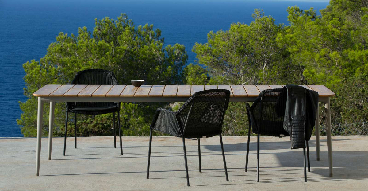 Core Dining Table by Cane-Line, showing core dining table with chairs in live shot.