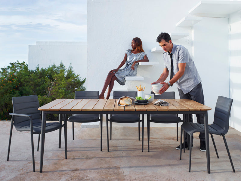 Core Dining Table by Cane-Line, showing core dining table with chairs in live shot.