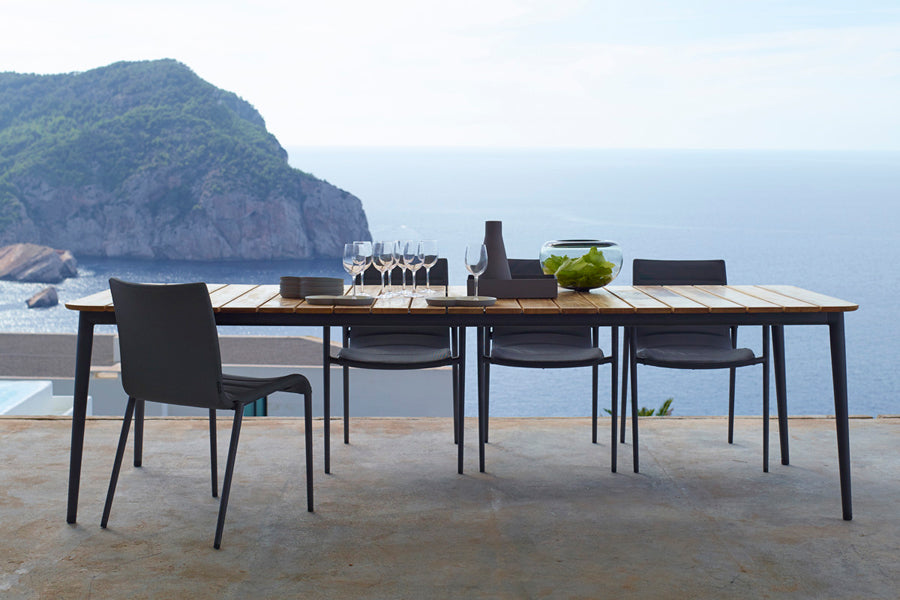 Core Dining Table by Cane-Line, showing core dining table with chairs in live shot.
