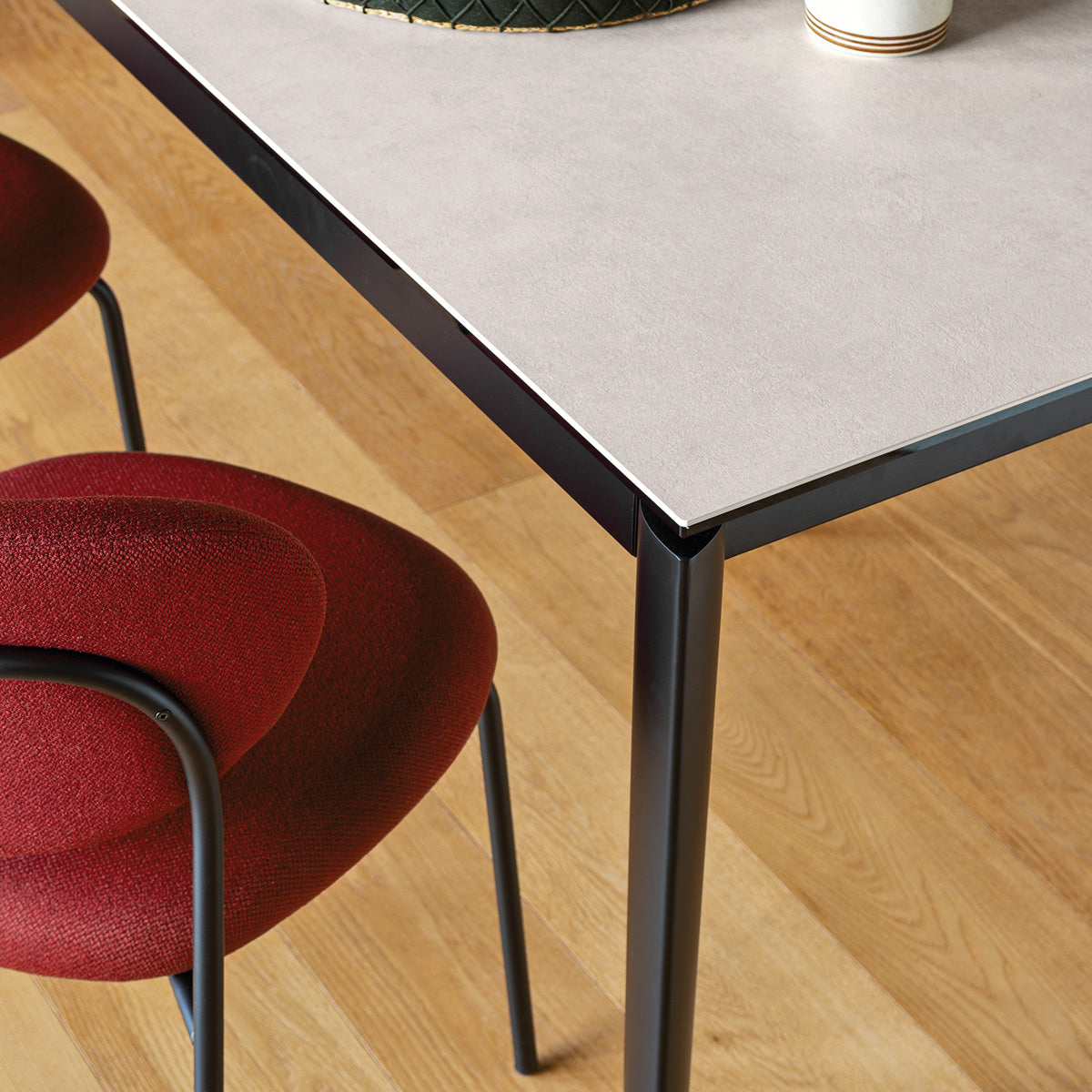 Cozy Chair by Connubia, showing closeup view of cozy chair with table in live shot.