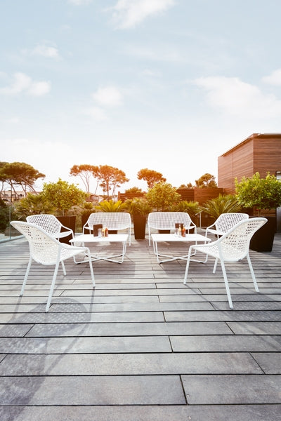 Croisette Armchair by Fermob, showing armchairs with table in live shot.
