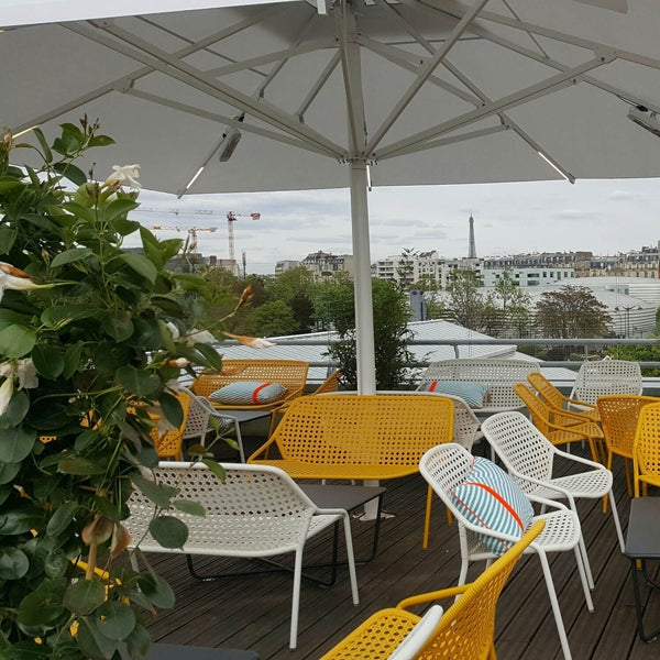 Croisette Armchair by Fermob, showing armchairs with table in live shot.