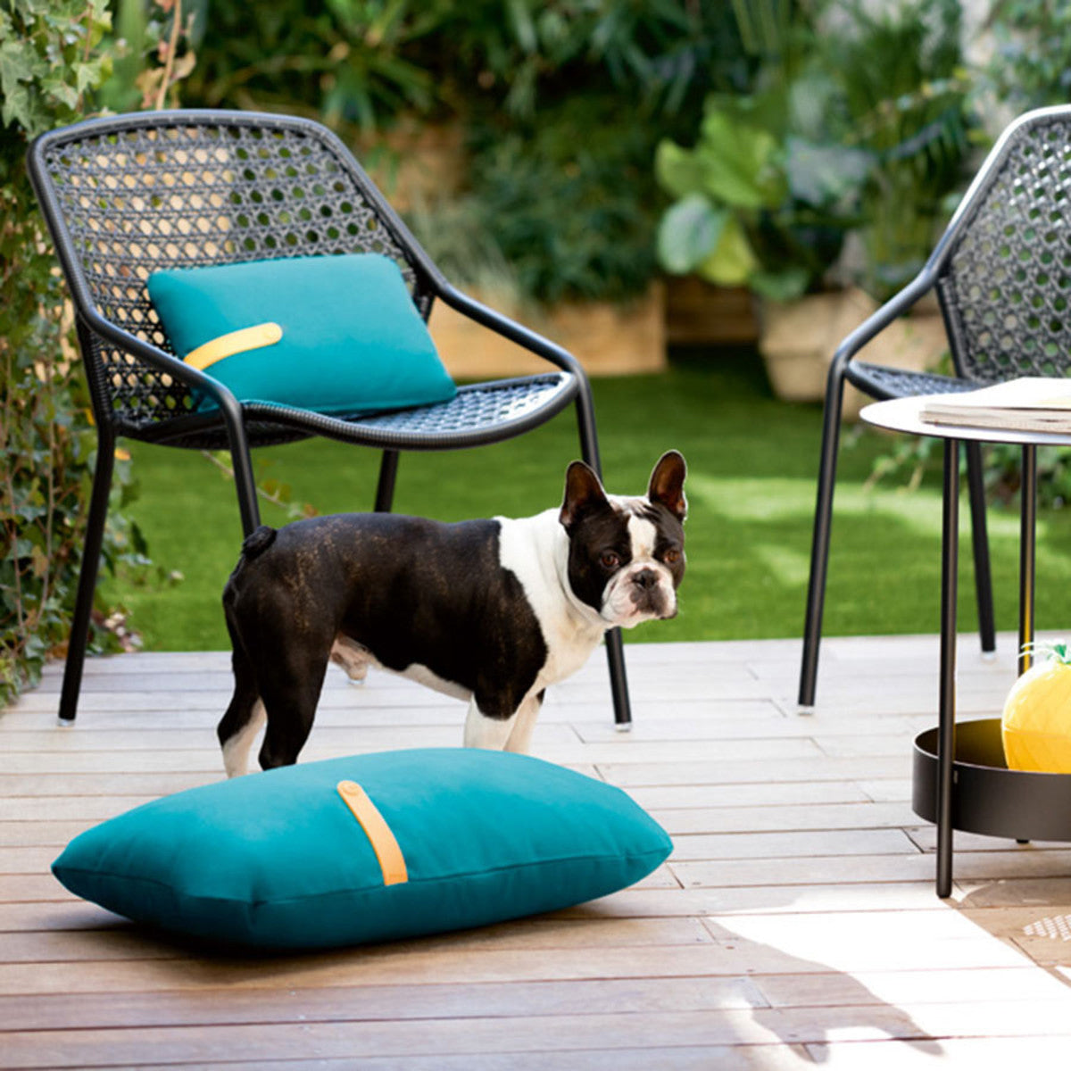 Croisette Armchair by Fermob, showing armchair with pillow in live shot.