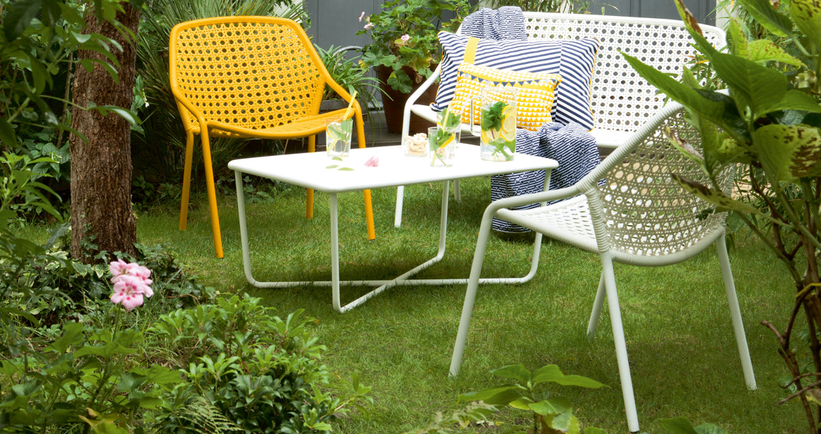 Croisette Low Table by Fermob, showing front view of low table with chair in the live shot.