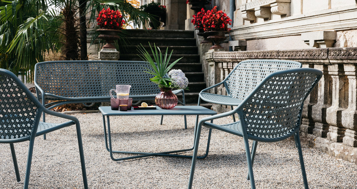 Croisette Low Table by Fermob, showing front view of low table with chair in the live shot.