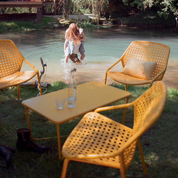 Croisette Low Table by Fermob, showing low table with chairs in live shot.