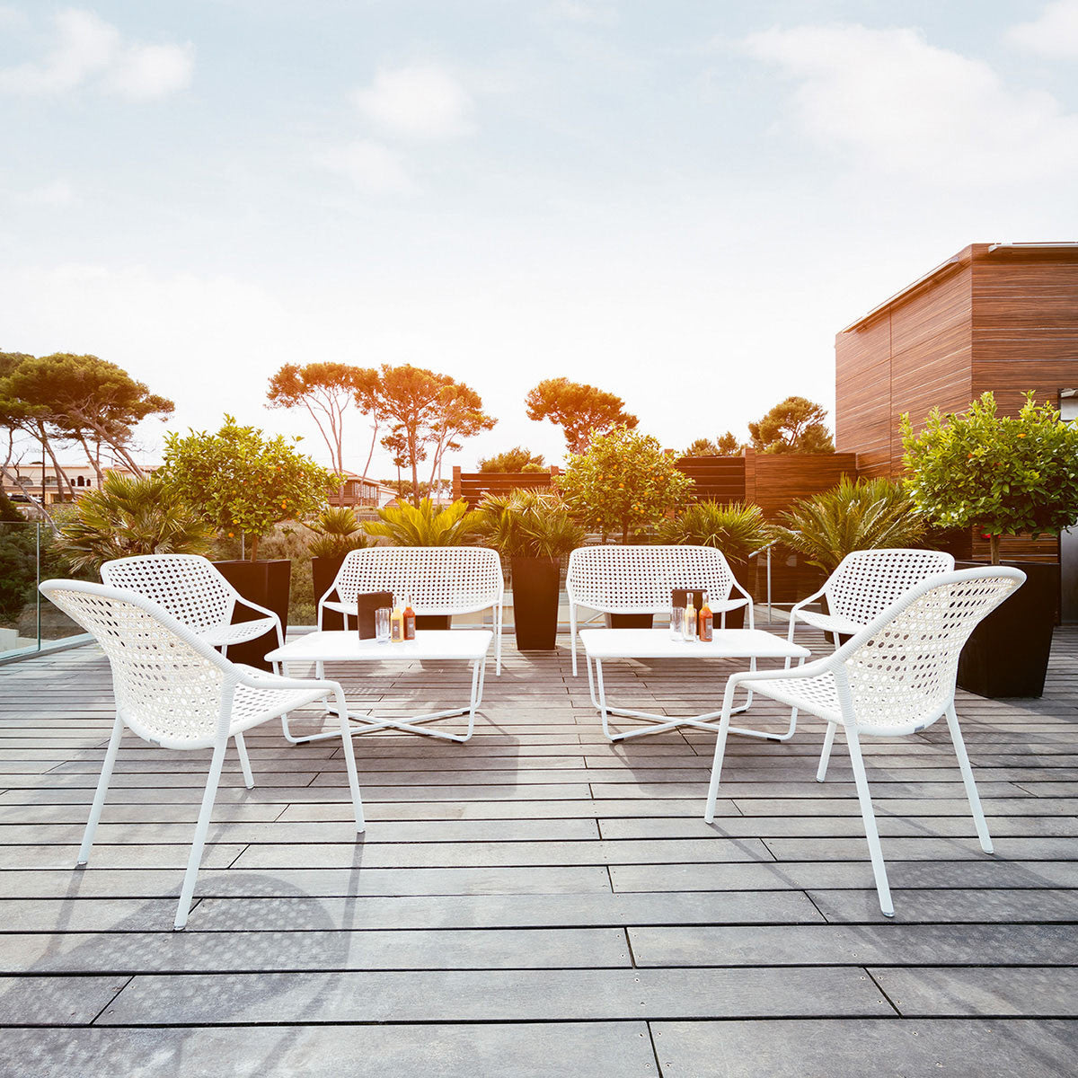 Croisette Low Table by Fermob, showing low table with chairs in live shot.