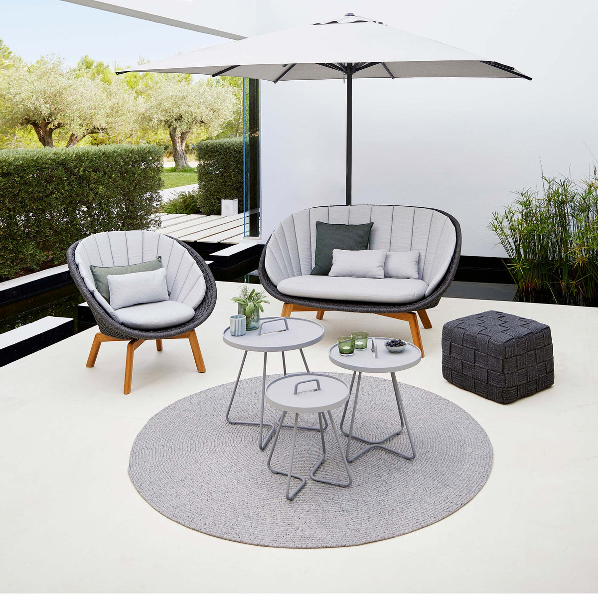 Cube Footstool by Cane-Line, showing cube footstool in live shot.