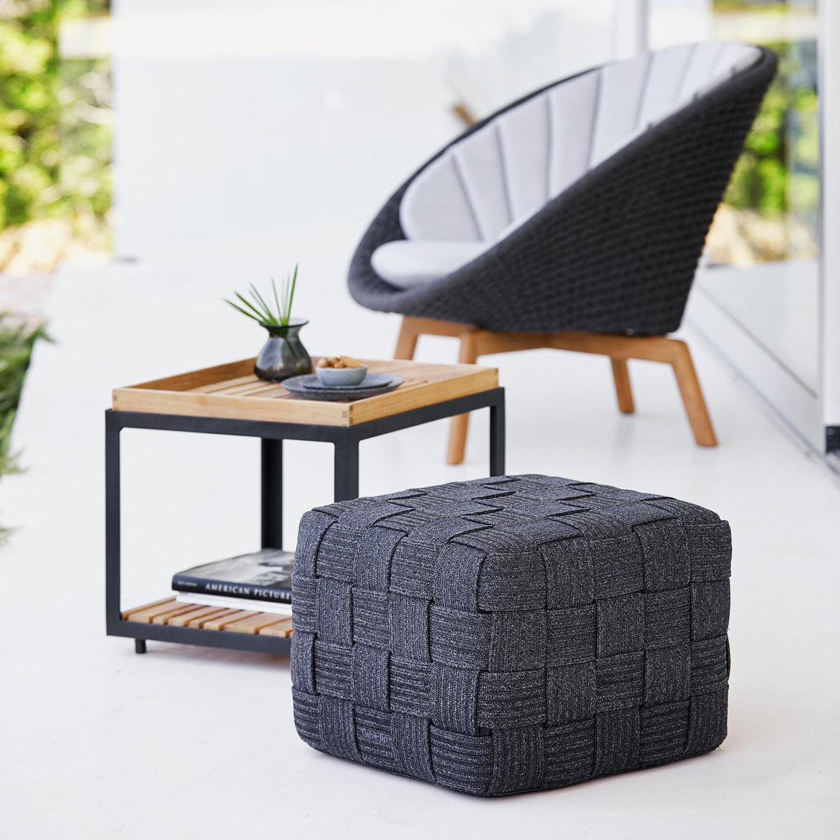 Cube Footstool by Cane-Line, showing cube footstool in live shot.