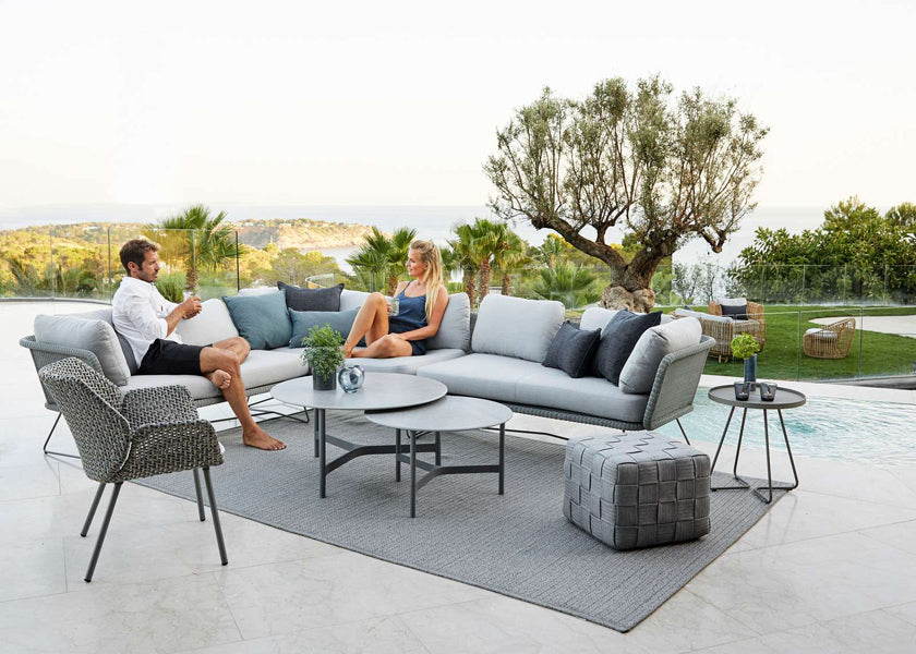 Cube Footstool by Cane-Line, showing cube footstool in live shot.
