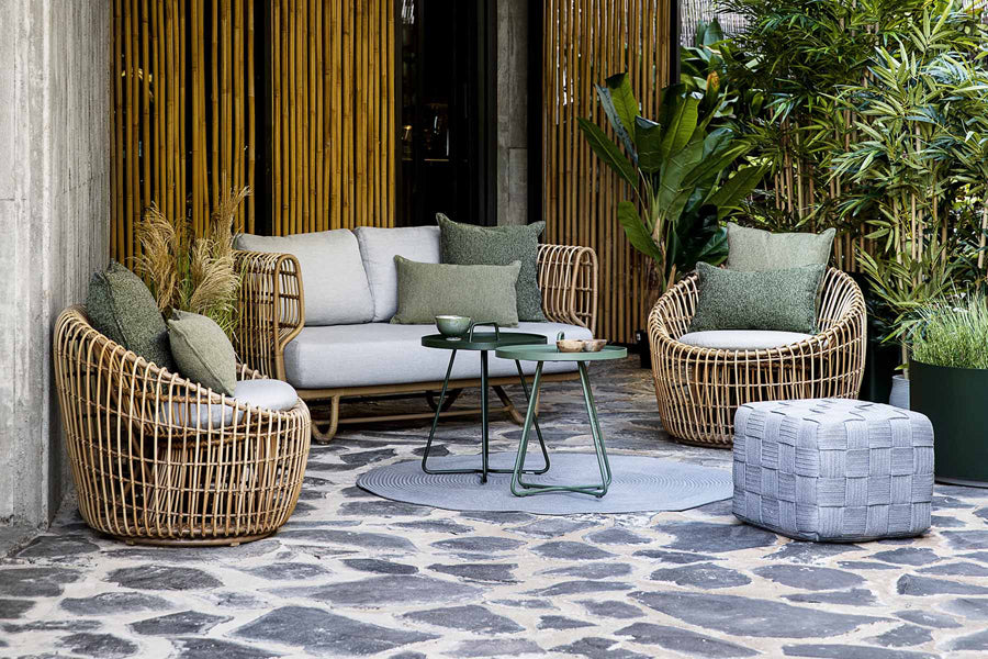 Cube Footstool by Cane-Line, showing cube footstool in live shot.