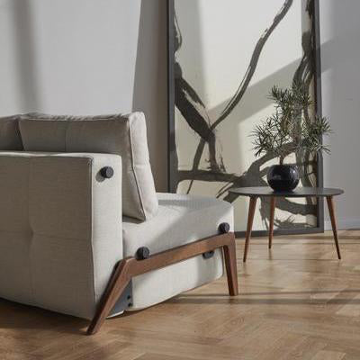 Cubed Sofa Bed with Dark Wood Legs by Innovation, showing cubed sofa bed with dark wood legs with table in live shot.