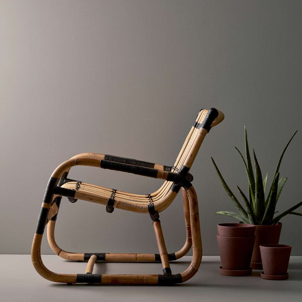 Curve Indoor Lounge Chair by Cane-Line, showing curve indoor lounge chair in live shot.