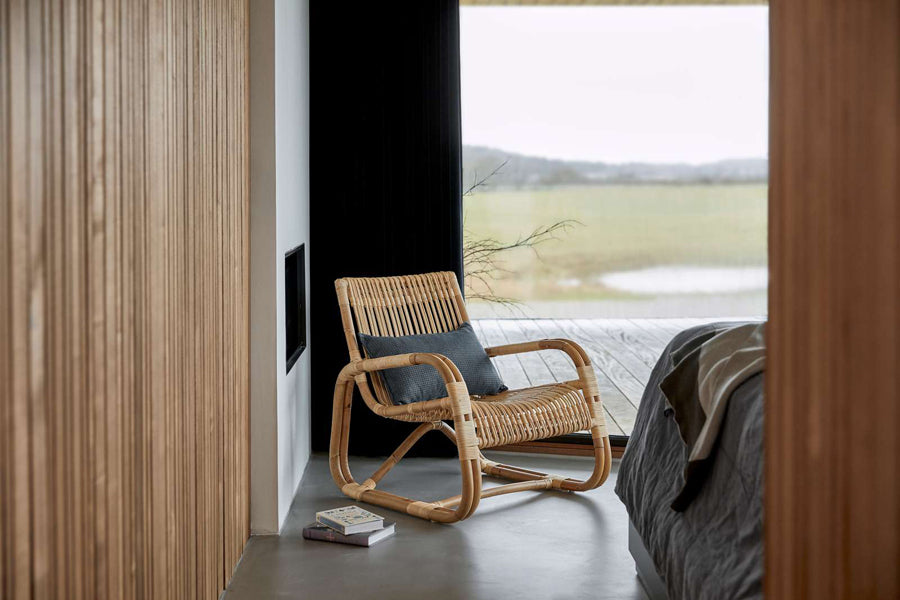 Curve Indoor Lounge Chair by Cane-Line, showing curve indoor lounge chair in live shot.