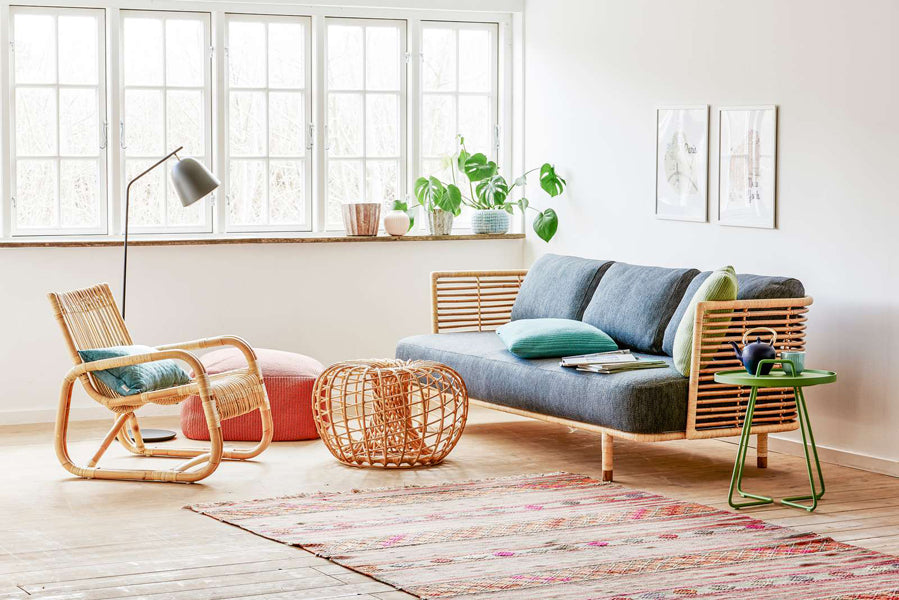 Curve Indoor Lounge Chair by Cane-Line, showing curve indoor lounge chair with sofa & table in live shot.