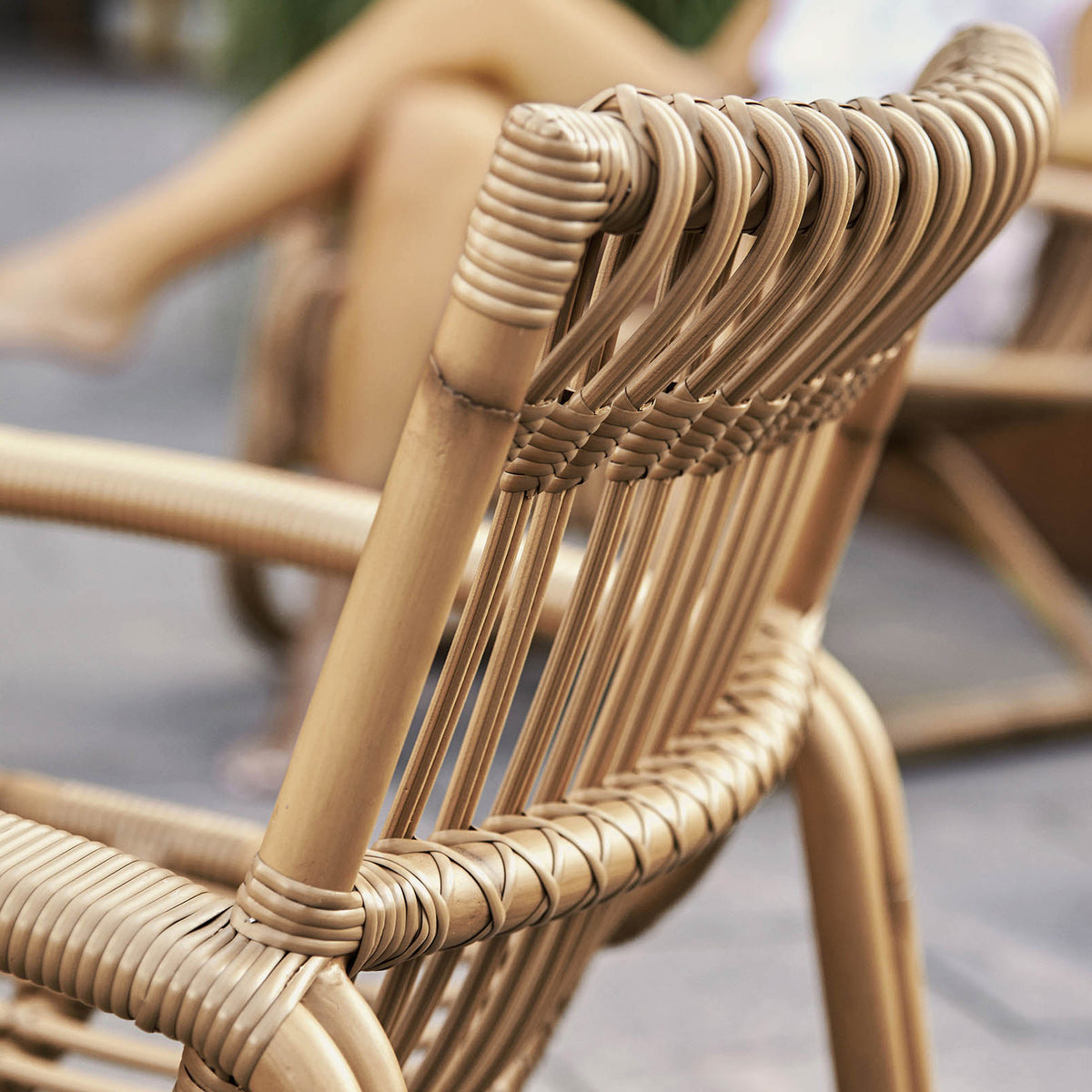 Curve Outdoor Lounge Chair by Cane-line, showing closeup view of curve outdoor lounge chair in live shot.