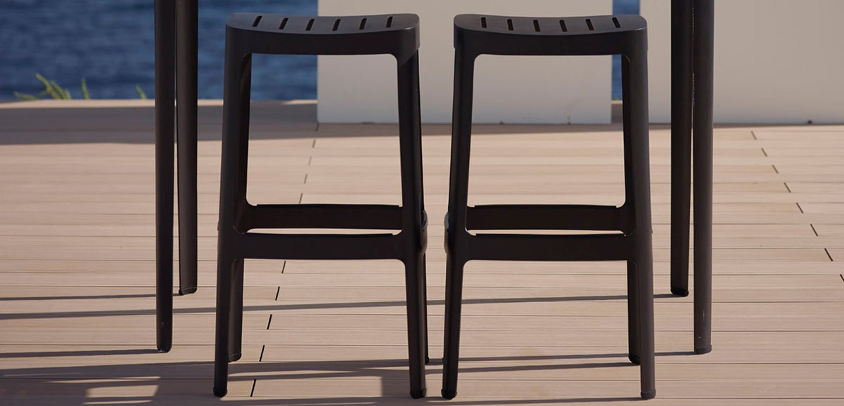 Cut High Bar Stool by Cane-Line , showing cut high bar stools in live shot.