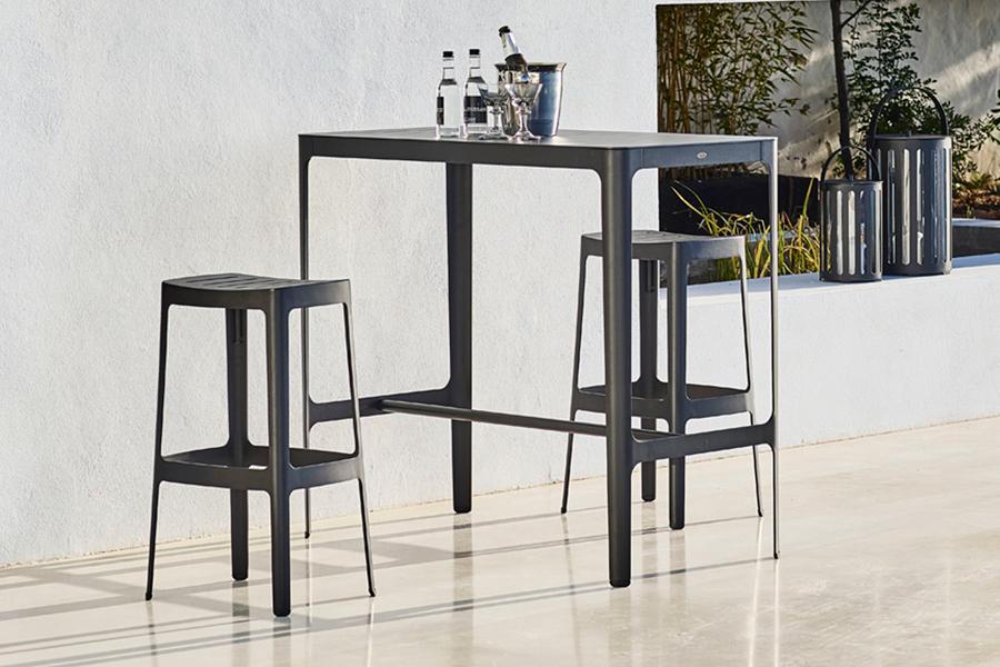 Cut High Bar Stool by Cane-Line , showing cut high bar stools in live shot.