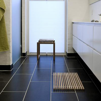 Dania Bathroom Mat by Skagerak, showing dania bathroom mat with cutter stool in live shot.