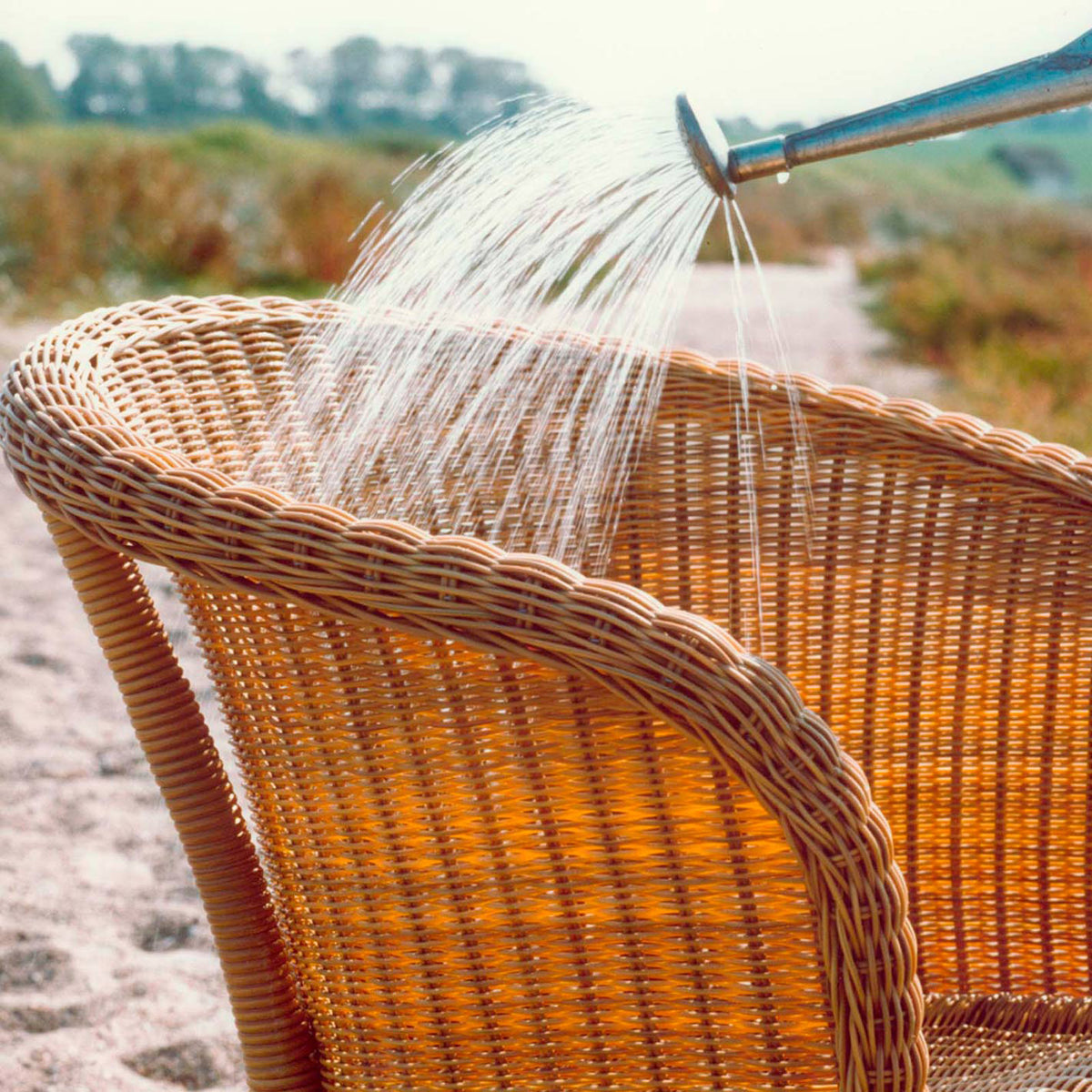 Derby Arm Chair by Cane-Line, showing closeup view of derby arm chair in live shot.