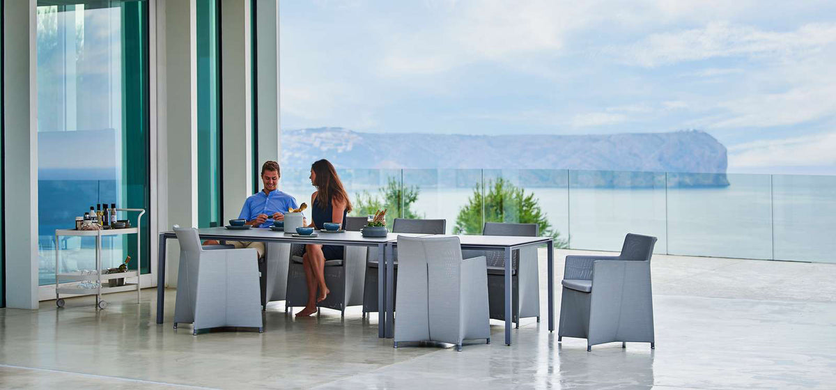 Diamond Outdoor Dining Armchair by Cane-Line, showing diamond outdoor dining armchairs in live shot.