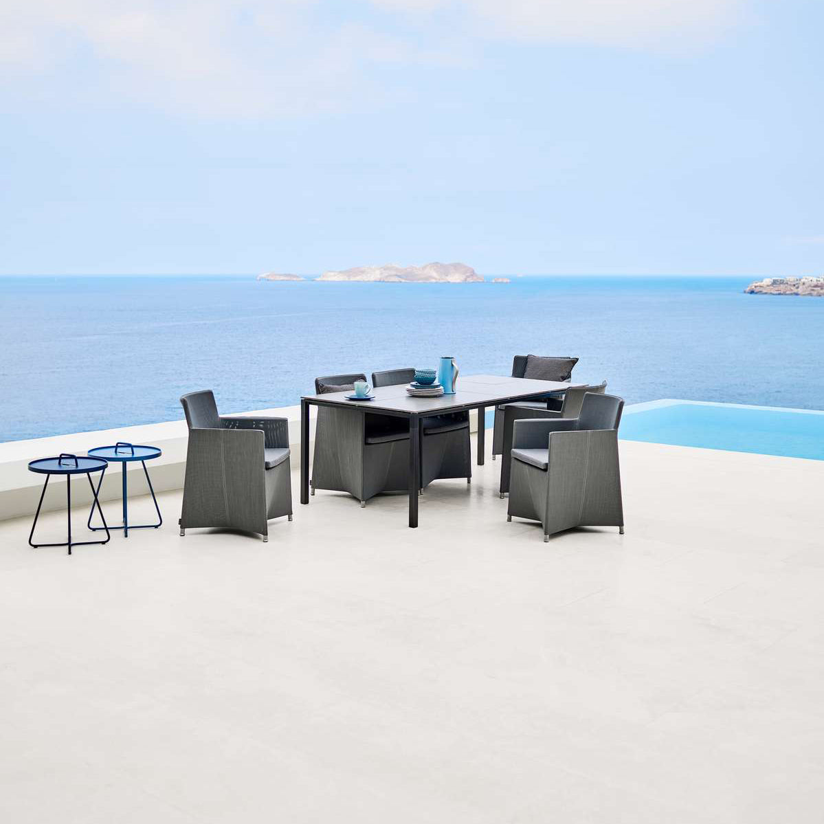 Diamond Outdoor Dining Armchair by Cane-Line, showing diamond outdoor dining armchairs in live shot.