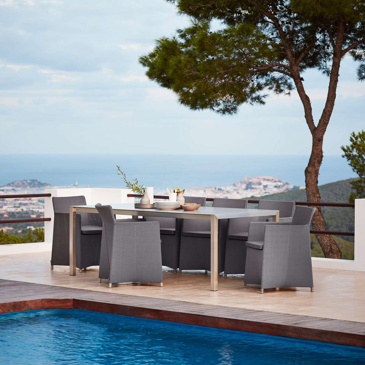 Diamond Outdoor Dining Armchair by Cane-Line, showing diamond outdoor dining armchairs in live shot.