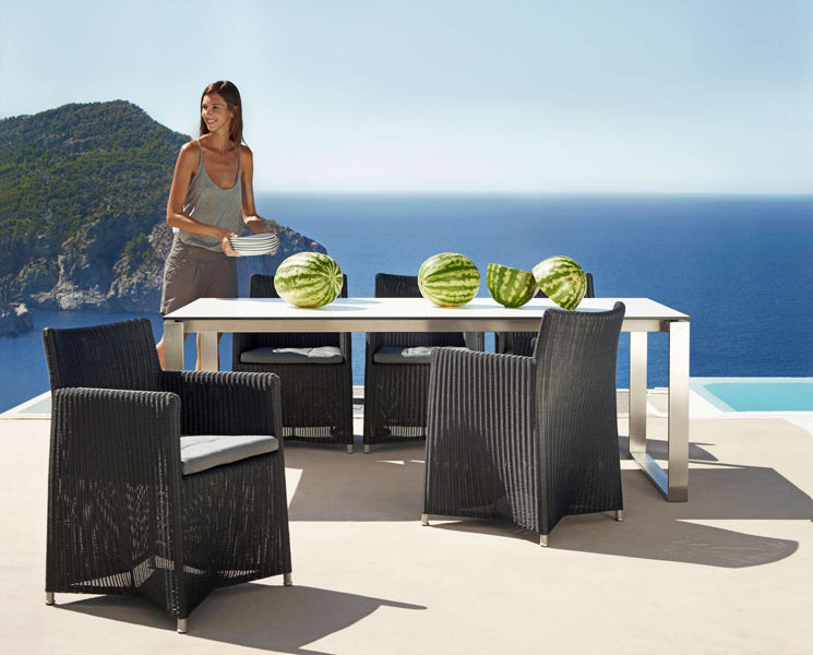 Diamond Outdoor Dining Armchair by Cane-Line, showing diamond outdoor dining armchairs in live shot.