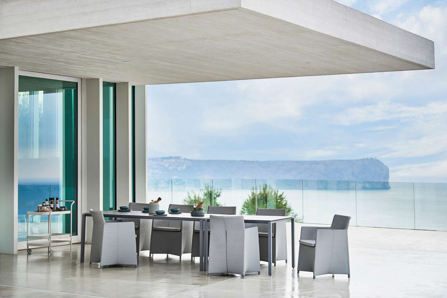 Diamond Outdoor Dining Armchair by Cane-Line, showing diamond outdoor dining armchairs in live shot.