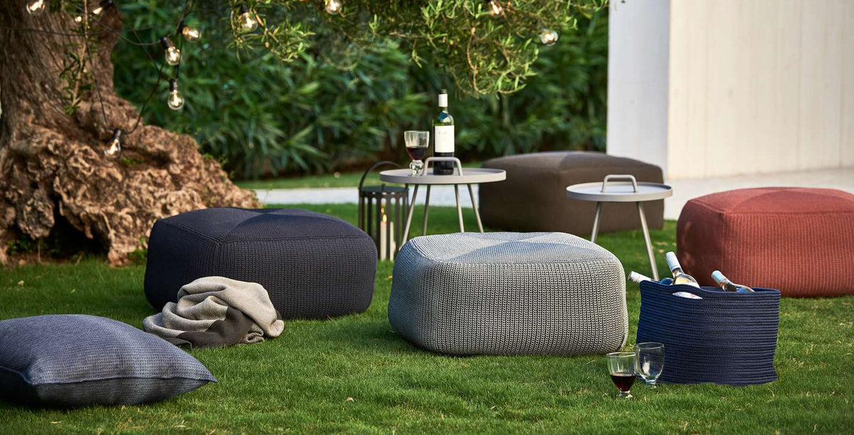 Divine Footstool by Cane-Line, showing divine footstools in live shot.