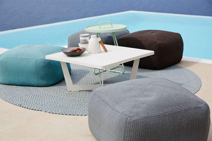 Divine Footstool by Cane-Line, showing divine footstools in live shot.