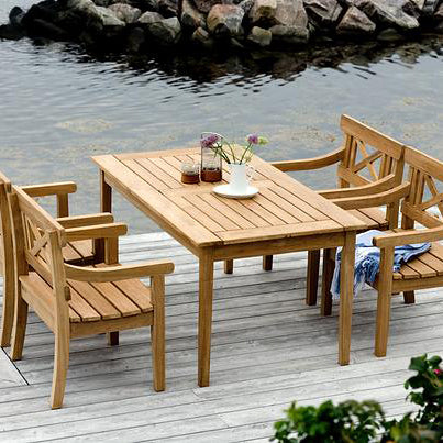 Drachmann Rectangle Teak Table by Skagerak, showing rectangle teak table with bench & chairs in live shot.