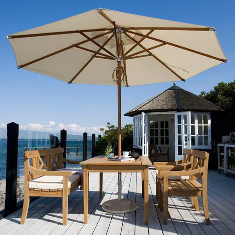 Drachmann Rectangle Teak Table by Skagerak, showing rectangle teak table with bench, chairs & umbrella in live shot.
