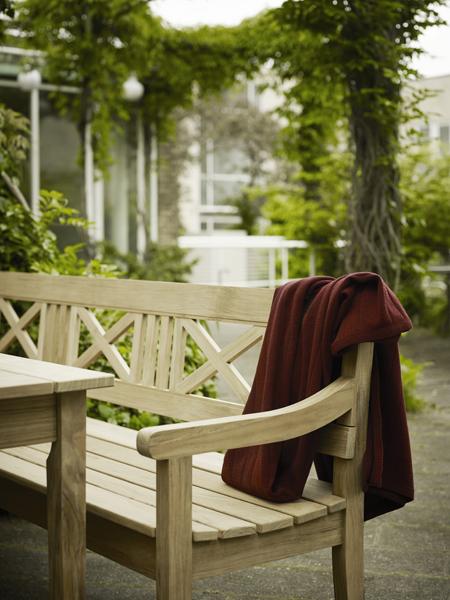 Drachmann Bench by Skagerak, showing closeup of drachmann bench with table in live shot.