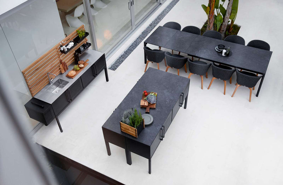Drop Kitchen Module by Cane-Line, showing drop kitchen modules with chairs & table in live shot.