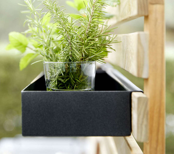 Drop Outdoor Teak Wall by Cane-Line, showing drop outdoor teak wall with drop module in live shot.