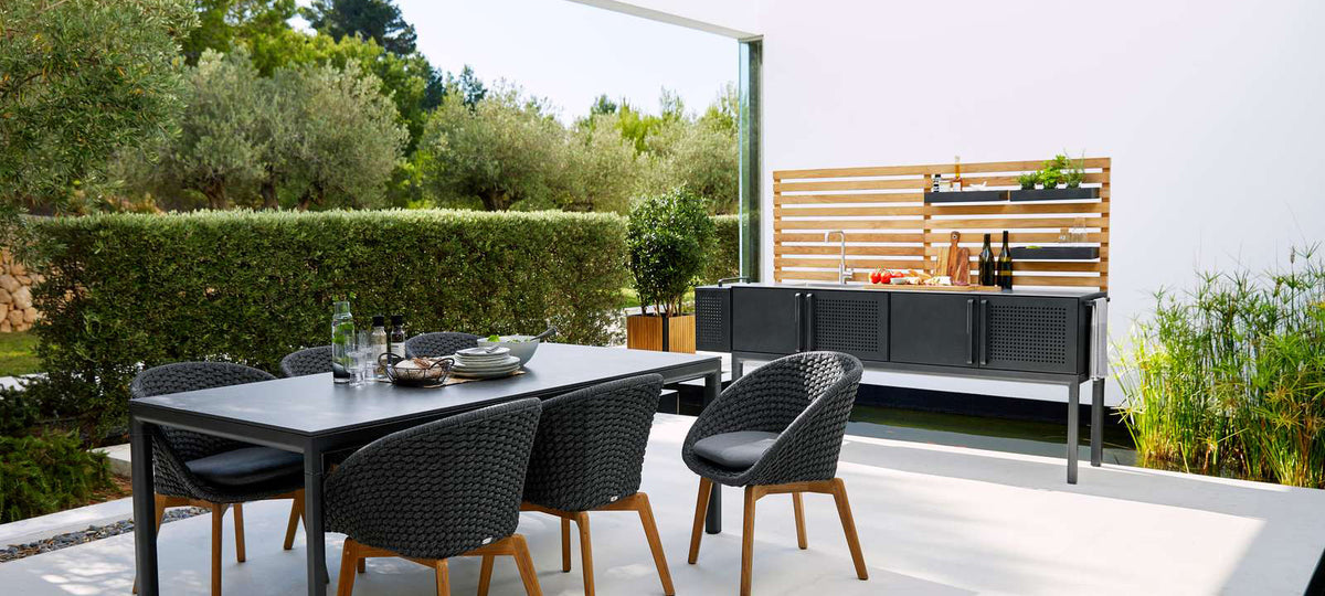 Drop Outdoor Teak Wall by Cane-Line, showing drop outdoor teak wall with drop double module in live shot.