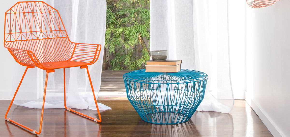 Drum Ottoman / Table by Bend, showing drum ottoman/table with chair in live shot.
