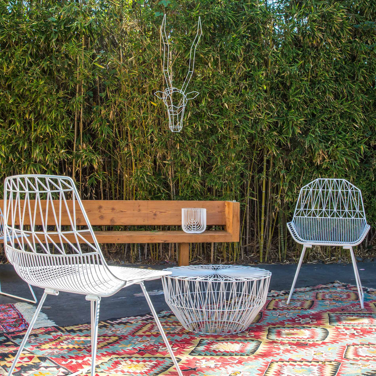 Drum Ottoman / Table by Bend, showing drum ottoman/table with chairs in live shot.