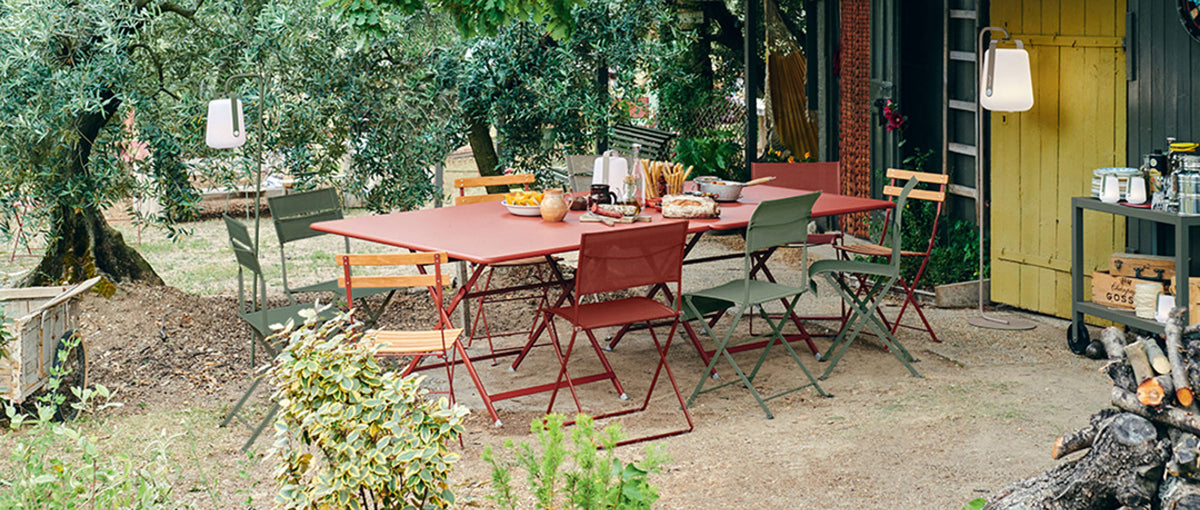 Dune Side Chair by Fermob, showing of dune side chairs with table in live shot.