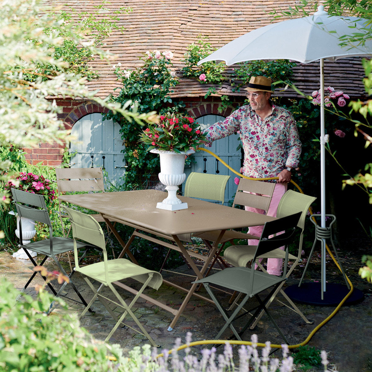 Dune Side Chair by Fermob, showing of dune side chairs with table in live shot.