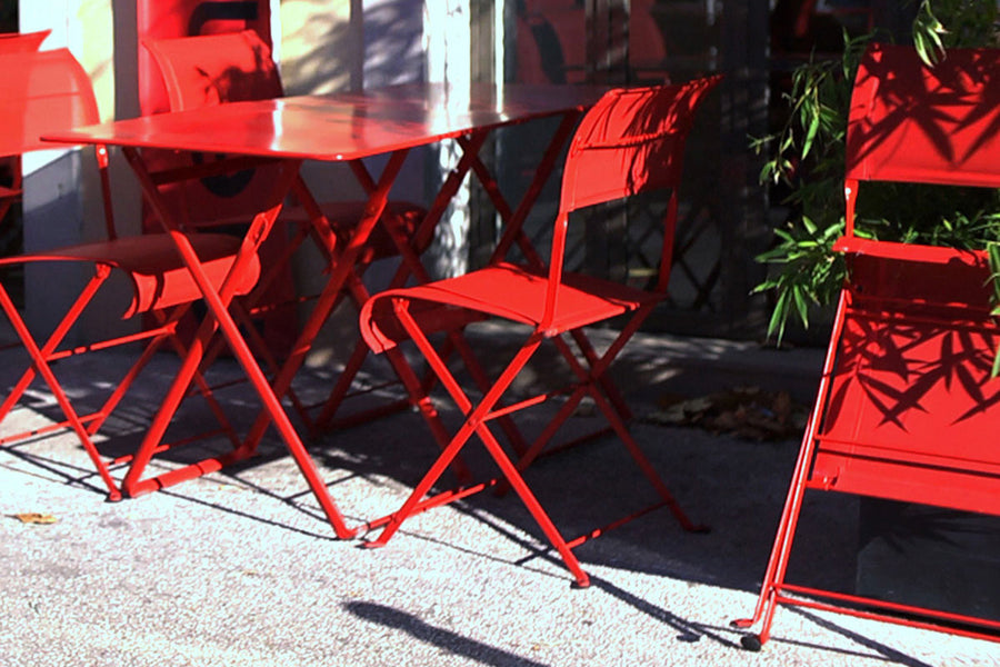 Dune Side Chair by Fermob, showing of dune side chairs with table in live shot.
