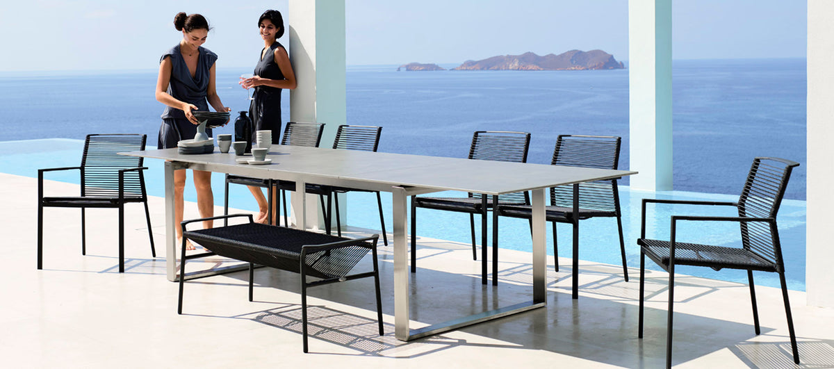 Edge Dining Table with Extension Leaves by Cane-Line, showing edge dining table with extension leaves in live shot.