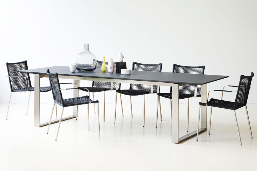 Edge Dining Table with Extension Leaves by Cane-Line, showing edge dining table with extension leaves in live shot.