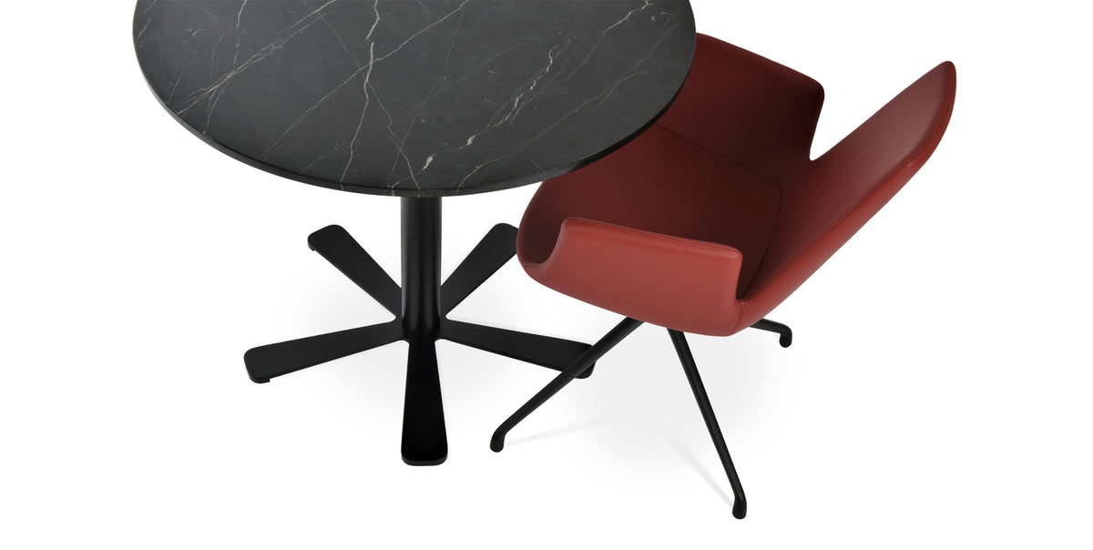 Eiffel Arm Spider Swivel Chair by SohoConcept, showing closeup view of chair in red leatherette with black base and daisy dining table in black marble top (34").