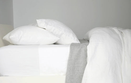 Eli White Pillow Cases (pair) by Area. showing side view of white pillow cases (pair).