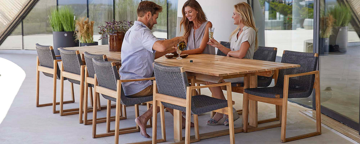 Endless Outdoor Dining Chair by Cane-Line, showing endless outdoor dining chairs with table in live shot.