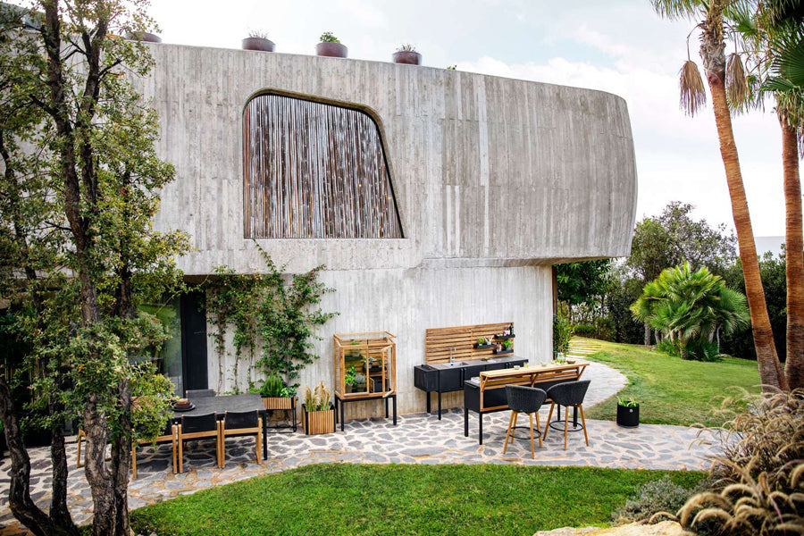 Endless Outdoor Dining Chair by Cane-Line, showing endless outdoor dining chairs with table in live shot.