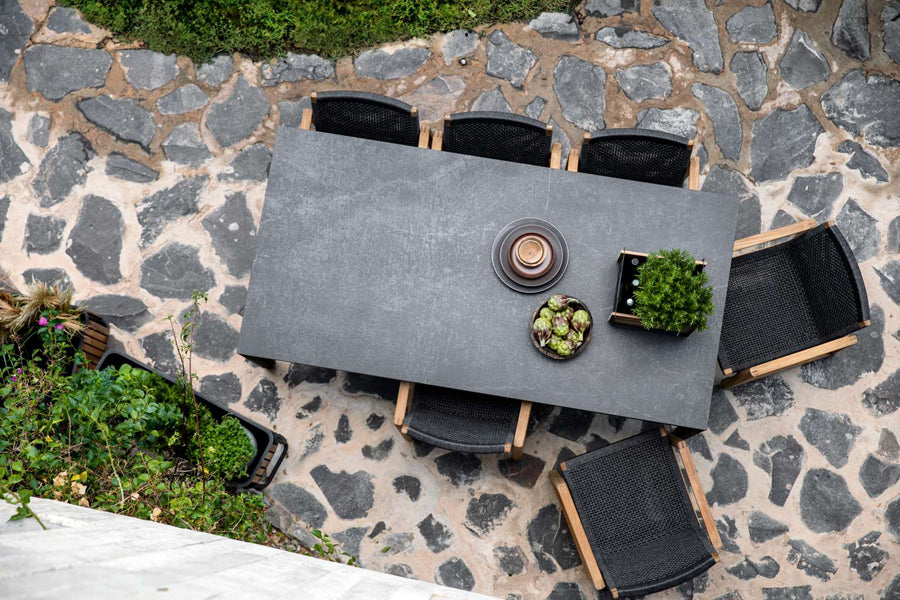 Endless Outdoor Dining Chair by Cane-Line, showing endless outdoor dining chairs with table in live shot.