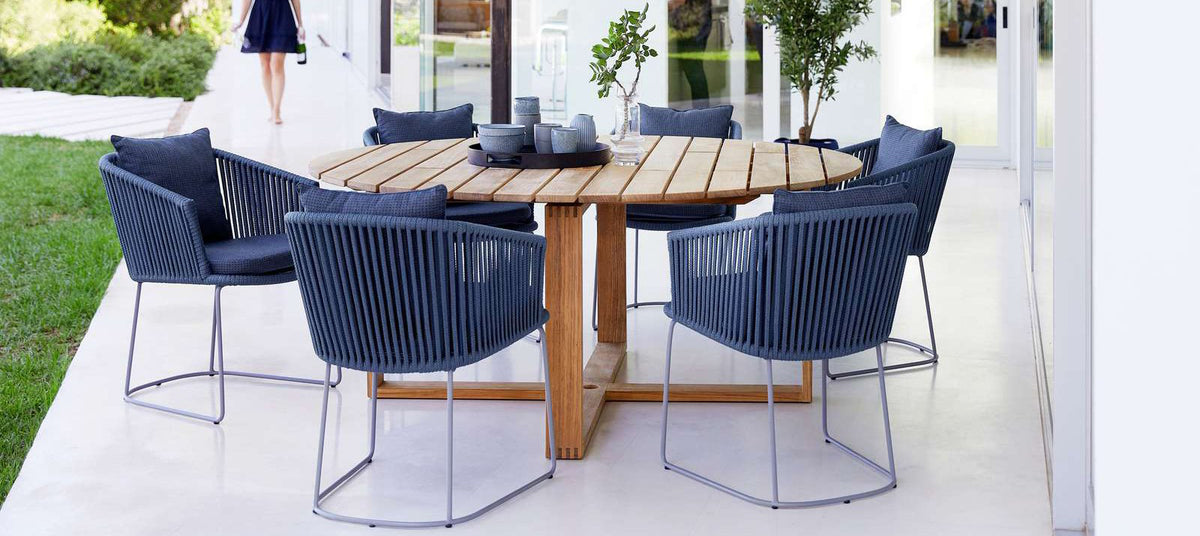 Endless Dining Table by Cane-Line, showing endless dining table with chairs in live shot.